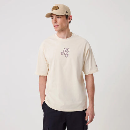The model is wearing this New Era Crest Graphic Oversized T-Shirt in open white. 3