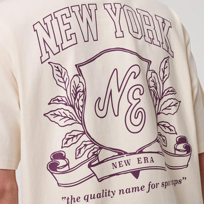 The model is wearing this New Era Crest Graphic Oversized T-Shirt in open white. 8
