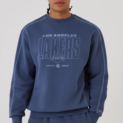 The model is wearing this NBA Graphic LA Lakers Crew Neck Sweater in dark blue. 4