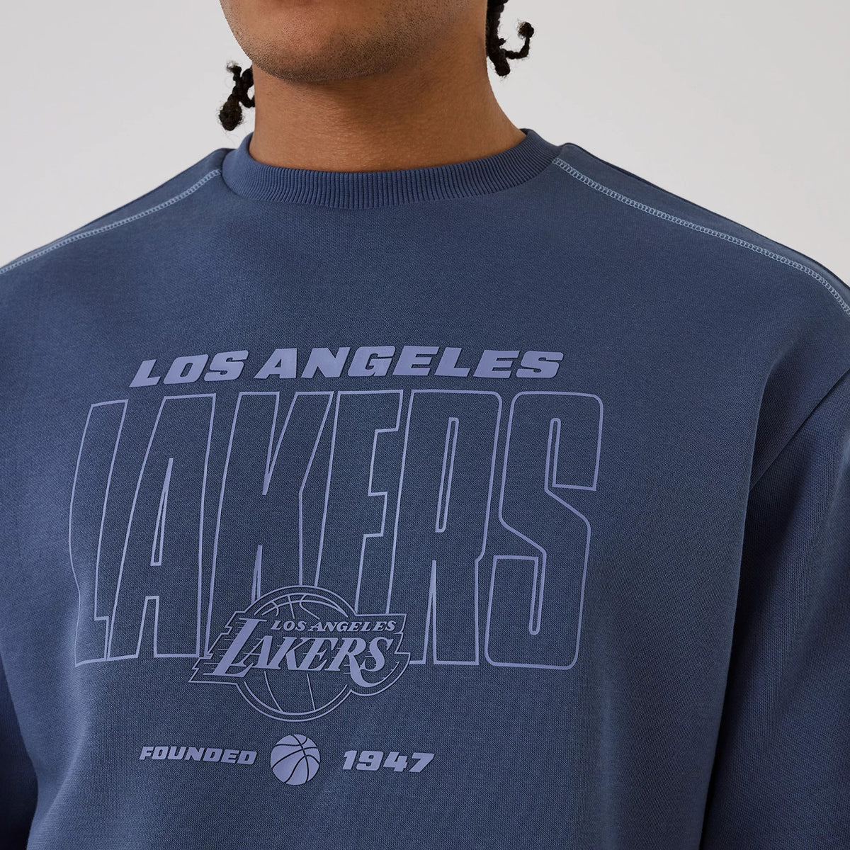 The model is wearing this NBA Graphic LA Lakers Crew Neck Sweater in dark blue. 3