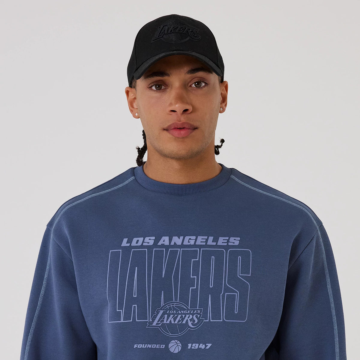 The model is wearing this NBA Graphic LA Lakers Crew Neck Sweater in dark blue. 5