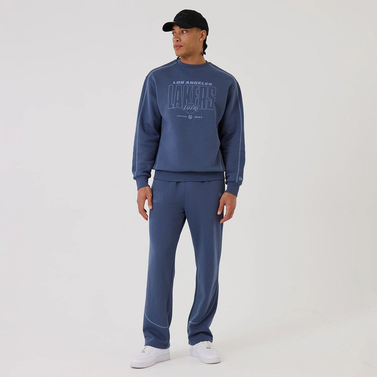 The model is wearing this NBA Graphic LA Lakers Crew Neck Sweater in dark blue. 8