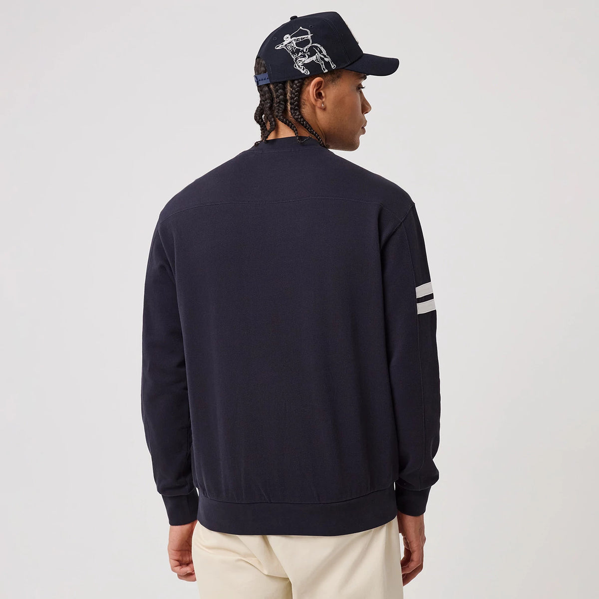 The model is wearing this MLB Arch Graphic New York Yankees Crew Neck Sweater in navy. 2