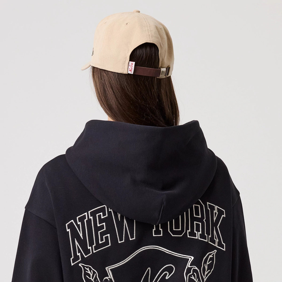 The model is wearing this New Era Crest Graphic Pullover Hoodie in navy. 6