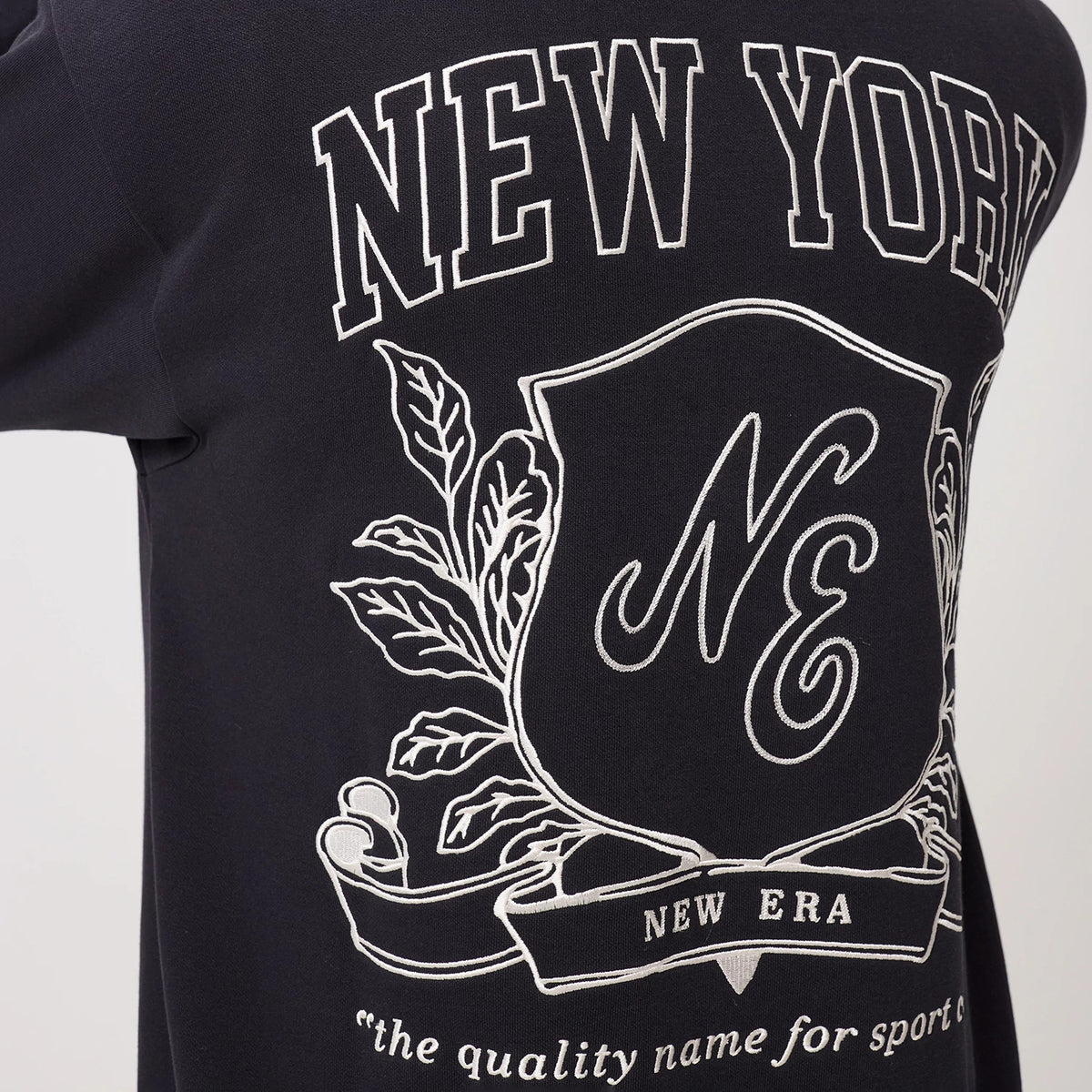 The model is wearing this New Era Crest Graphic Pullover Hoodie in navy. 8