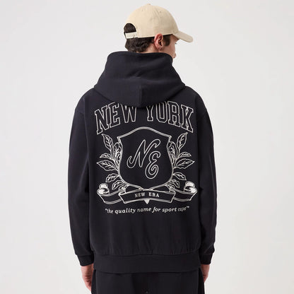 The model is wearing this New Era Crest Graphic Pullover Hoodie in navy. 2