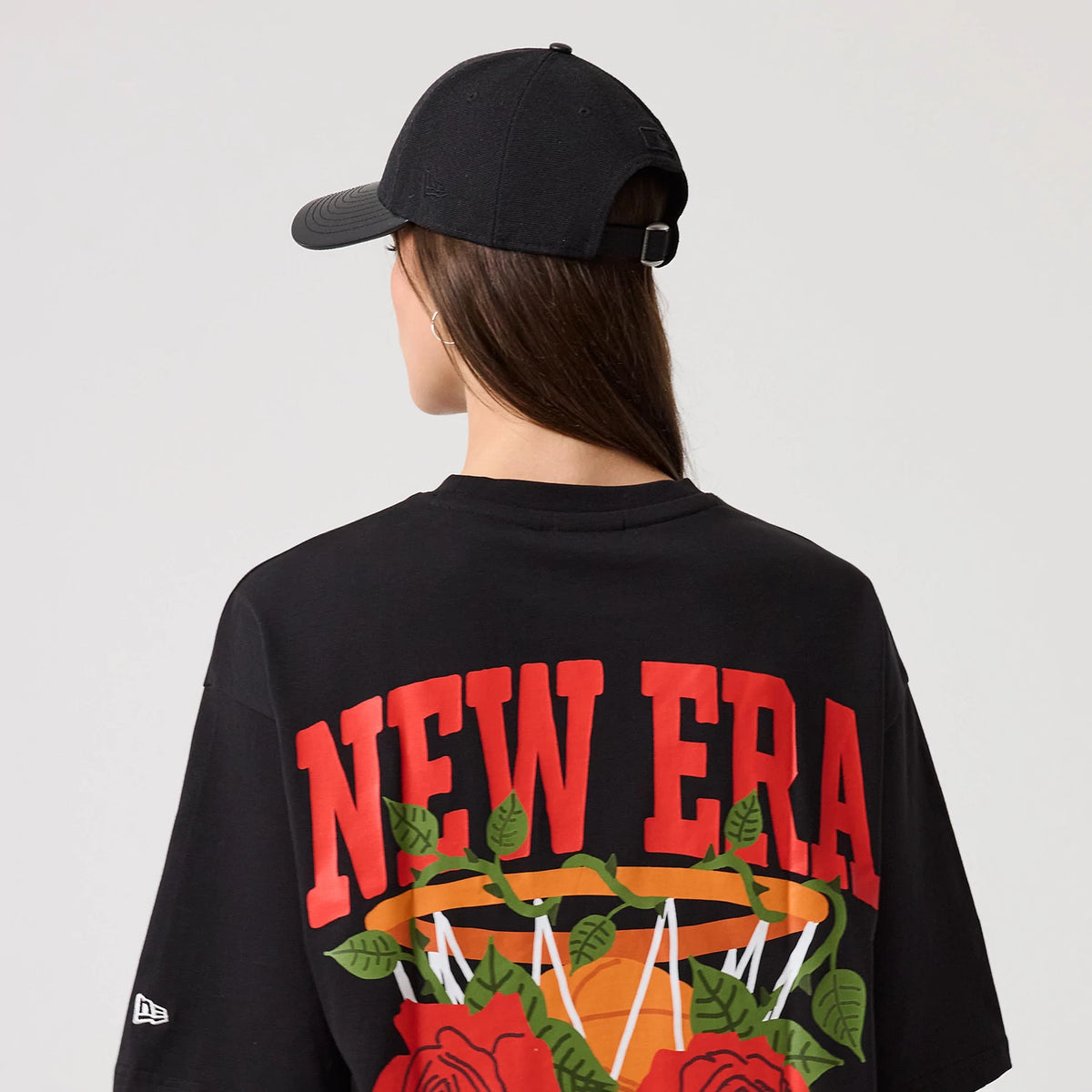 The model is wearing this New Era Floral Graphic T-Shirt in black. 6