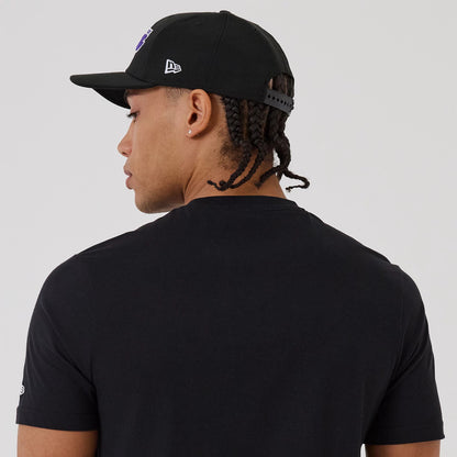 The model is wearing this NBA Graphic LA Lakers T-Shirt in black. 7