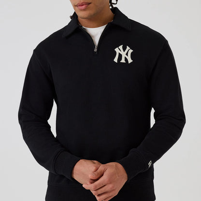 The model is wearing this MLB New York Yankees 1/4 Zip Sweater in black. 3