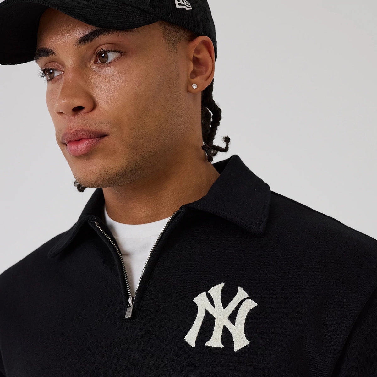 The model is wearing this MLB New York Yankees 1/4 Zip Sweater in black. 6