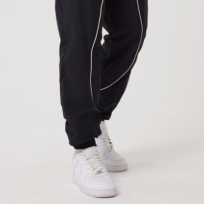 The model is wearing this MLB Piping New York Yankees Track Pants in navy. 6