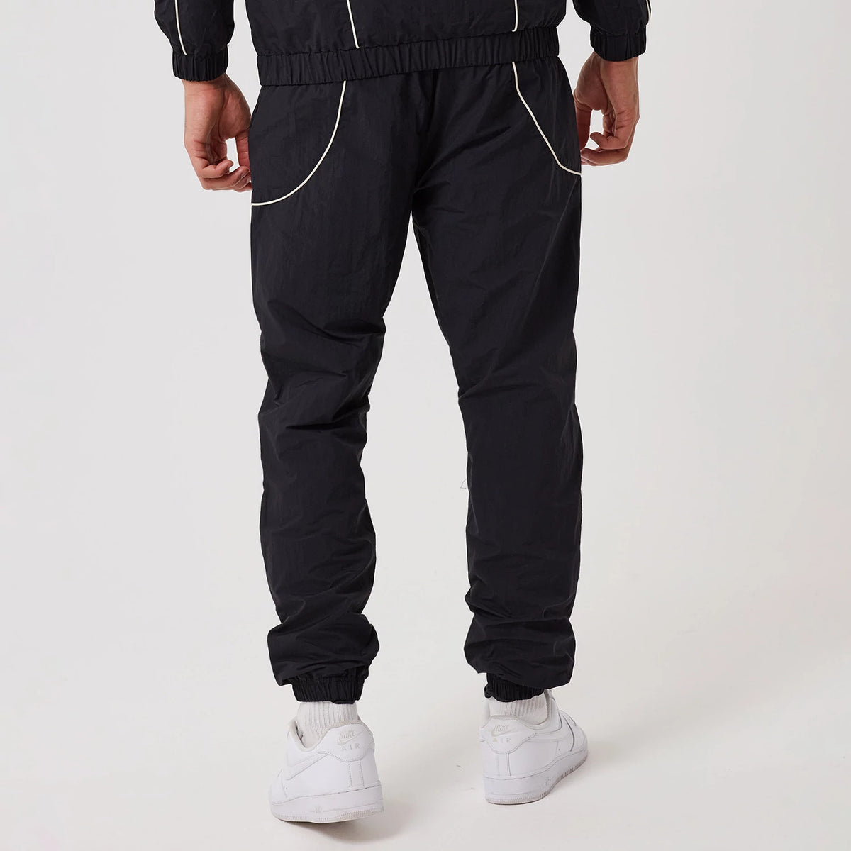 The model is wearing this MLB Piping New York Yankees Track Pants in navy. 2