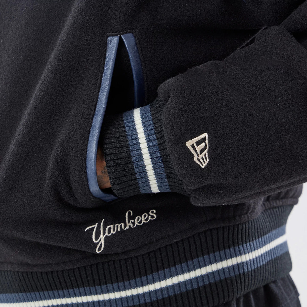The model is wearing this MLB New York Yankees Varsity Jacket in black. 4