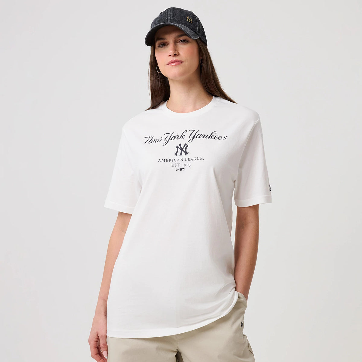 The model is wearing this MLB Linear New York Yankees T-Shirt in white. 4