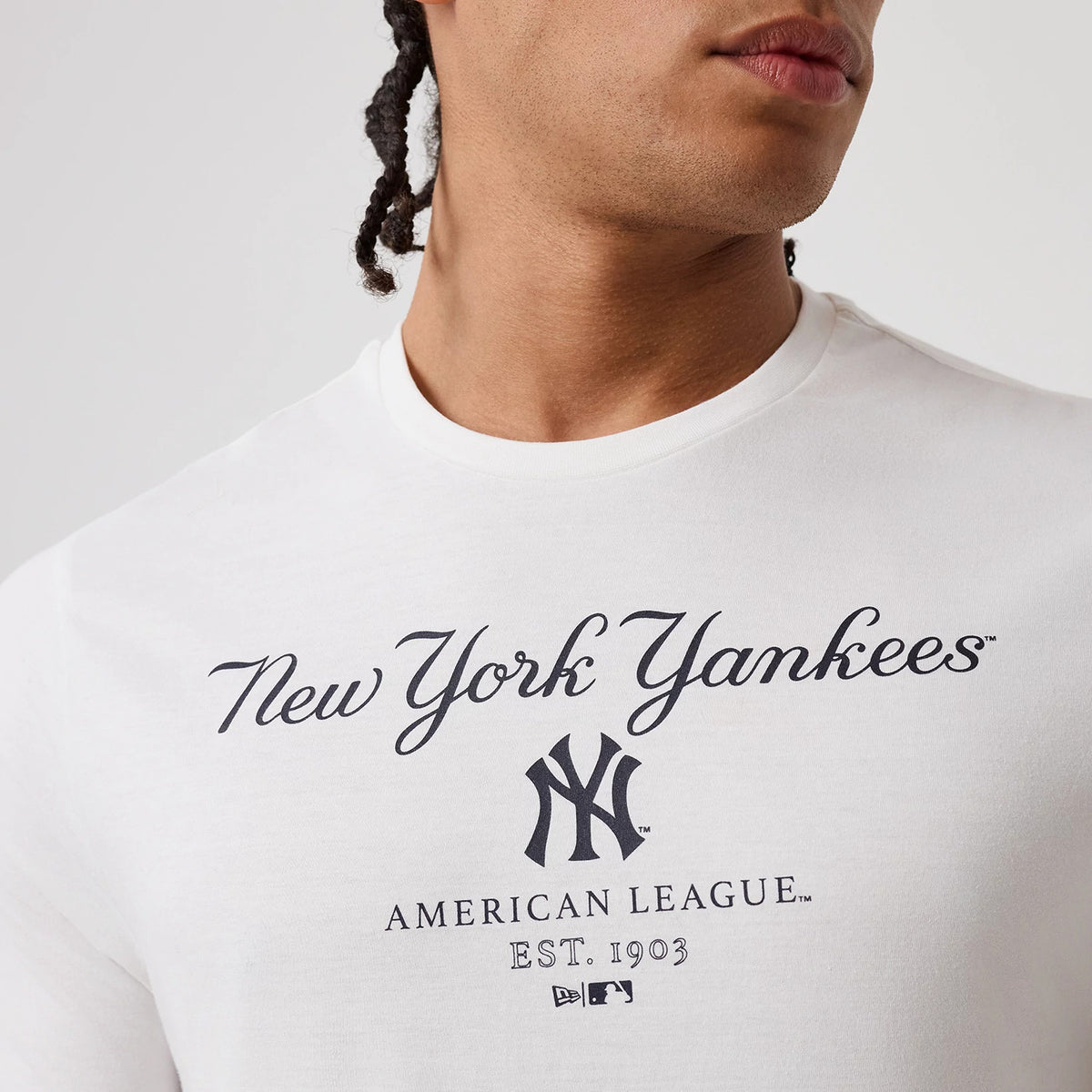 The model is wearing this MLB Linear New York Yankees T-Shirt in white. 5
