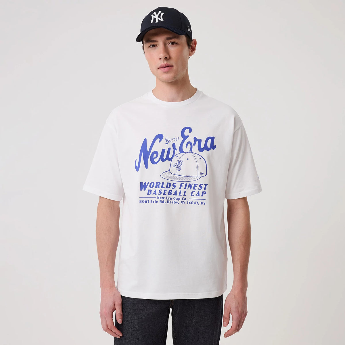 The model is wearing this New Era Heritage Oversized T-Shirt in white. 3