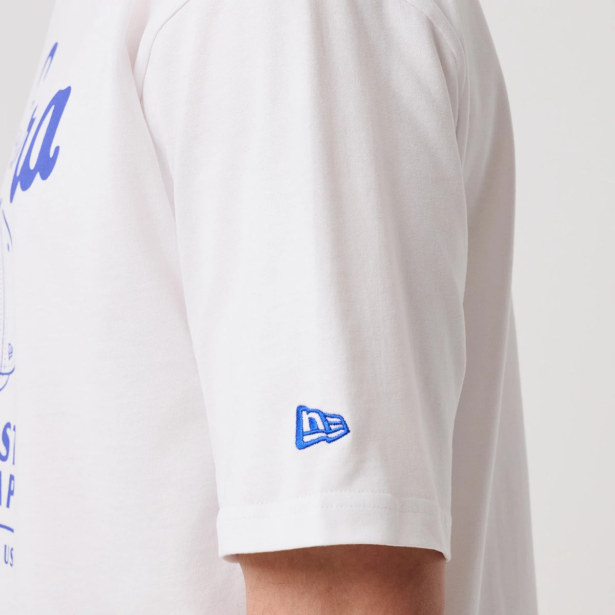 The model is wearing this New Era Heritage Oversized T-Shirt in white. 7