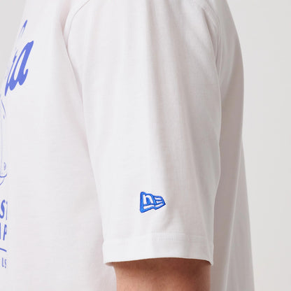 The model is wearing this New Era Heritage Oversized T-Shirt in white. 7