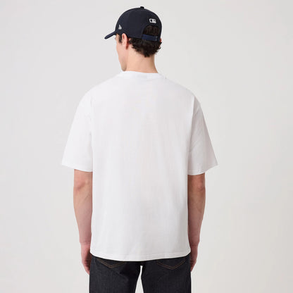 The model is wearing this New Era Heritage Oversized T-Shirt in white. 2