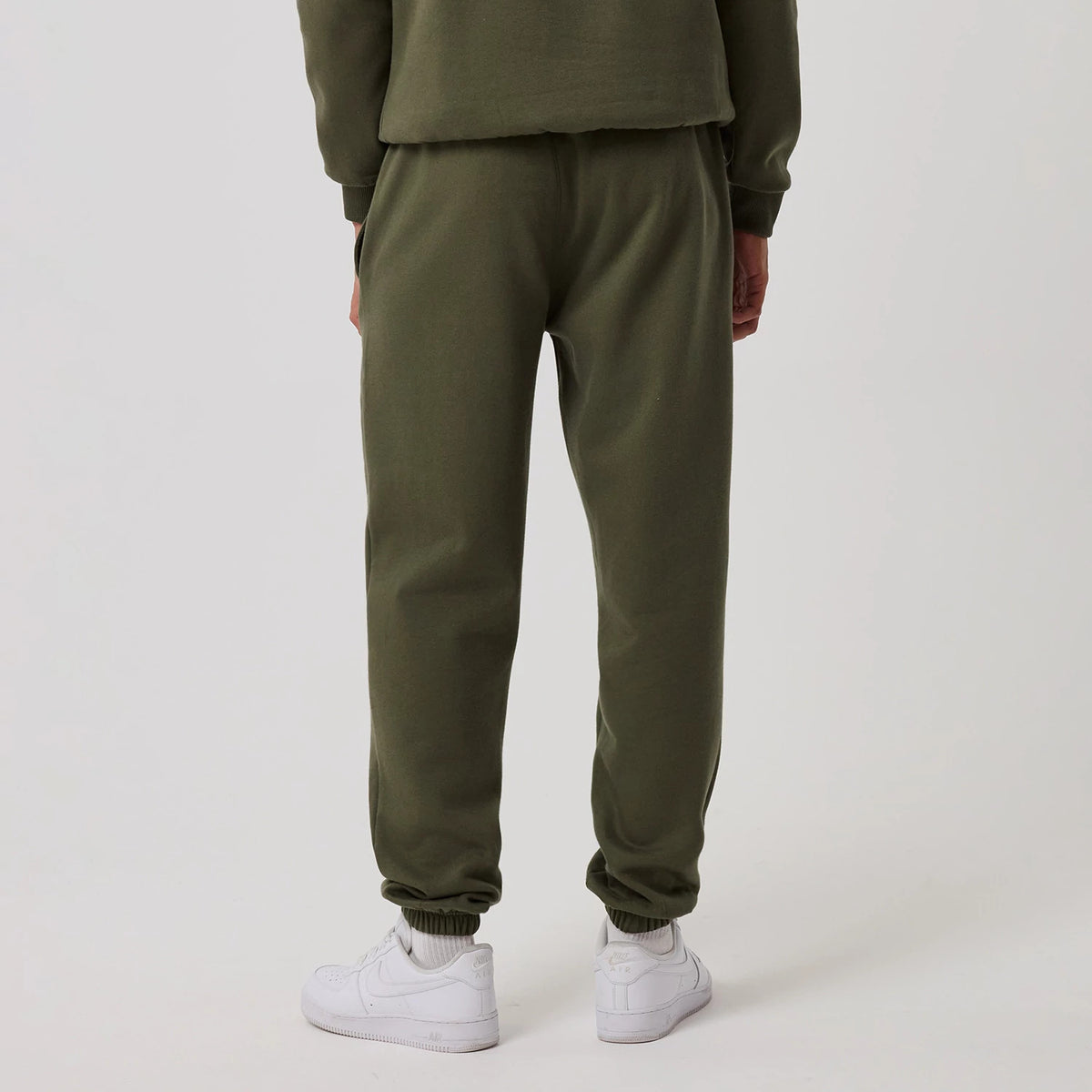 The model is wearing this MLB League Essential New York Yankees Joggers in green. 2