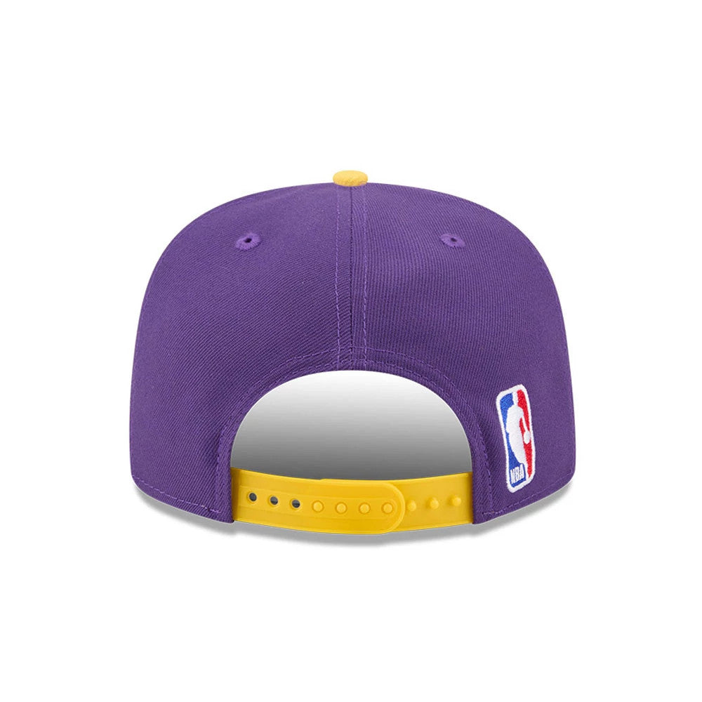 LA Lakers NBA Tip Off 2026 Purple New Era 9FIFTY A-Frame Snapback Adjustable Cap, rear view showing the NBA logo embroidered at the lower right back panel, a purple structured crown, and a yellow snapback closure.
