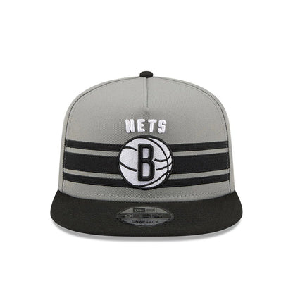 Brooklyn Nets NBA Tip Off 2026 Dark Grey New Era 9FIFTY A-Frame Snapback Adjustable Cap, front view showing the raised embroidered white NETS text and black B logo on the centre front panel, with a black flat visor featuring a 9FIFTY size sticker.