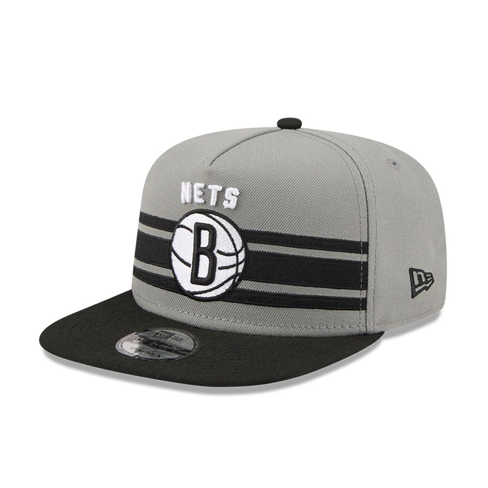 Brooklyn Nets NBA Tip Off 2026 Dark Grey New Era 9FIFTY A-Frame Snapback Adjustable Cap, front view showing a white embroidered Nets logo with a basketball graphic on the structured dark grey crown, featuring a black visor and 9FIFTY size sticker.