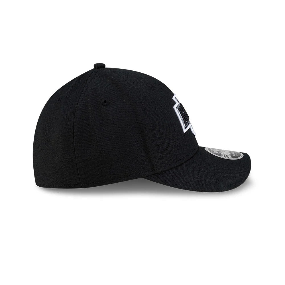 LA Kings NHL Team Black New Era 39THIRTY M-Crown Stretch Fit Cap, side view showing the raised black and white LA Kings logo embroidered on the front panel, curved black visor, and the structured shape of the black crown.