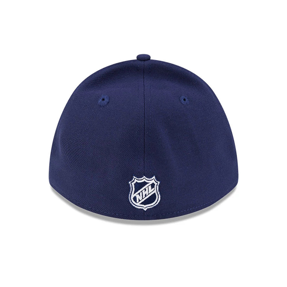 Toronto Maple Leafs NHL Team Navy New Era 39THIRTY M-Crown Stretch Fit Cap, rear view showing the white embroidered NHL shield logo centred on the back panels, with eyelets and a top button on the structured navy crown.