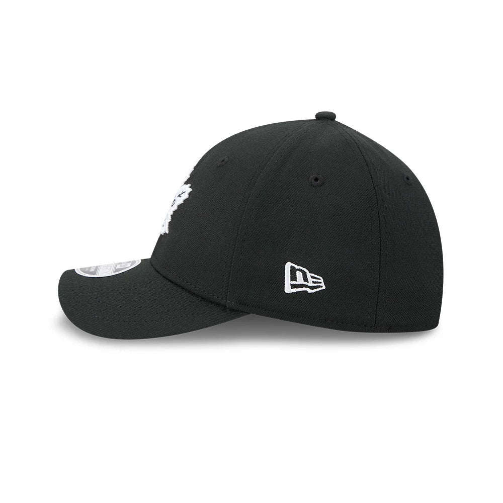 Toronto Maple Leafs NHL Black New Era 39THIRTY M-Crown Stretch Fit Cap, side view with the white embroidered New Era flag logo on the left side, a curved visor featuring a 39THIRTY size sticker, and black eyelets on the structured crown.
