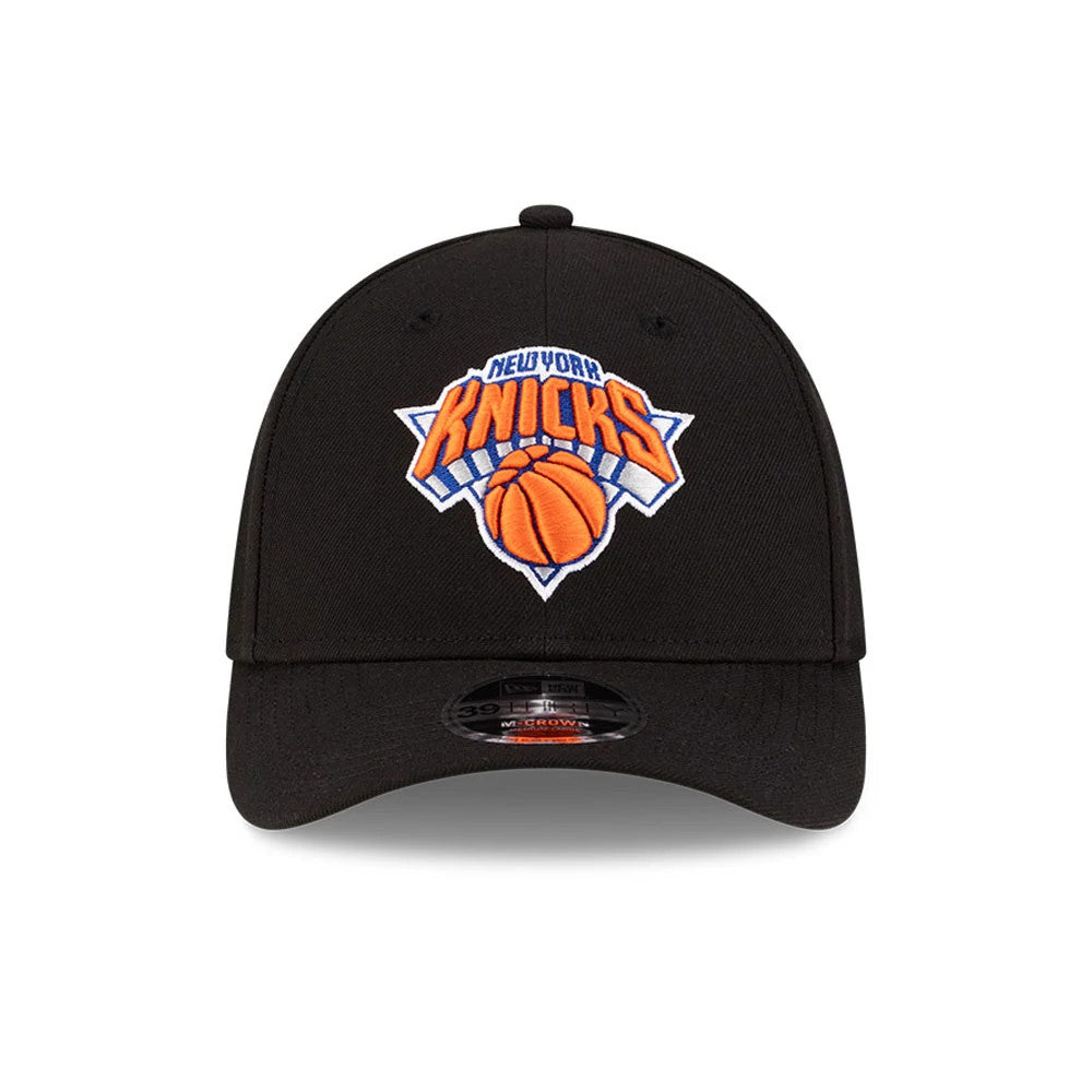 New York Knicks NBA Team Black New Era 39THIRTY M-Crown Stretch Fit Cap, front view showing the raised orange and blue embroidered Knicks logo on the front panel, with a curved black visor and 39THIRTY size sticker.