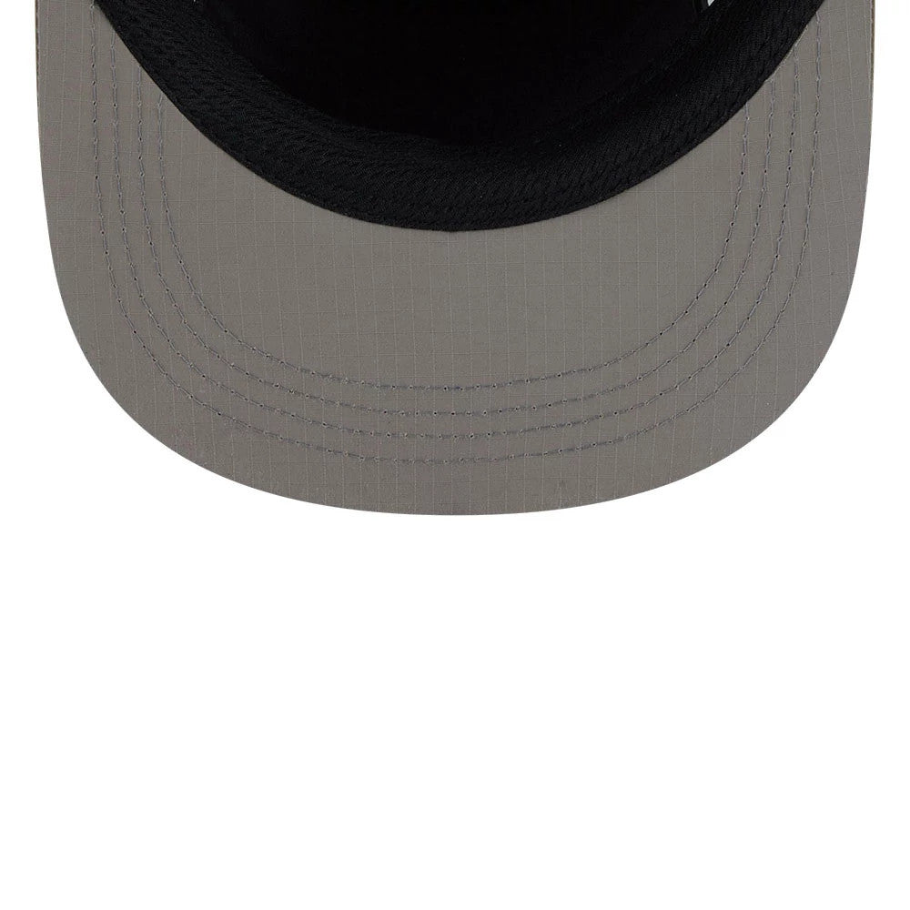New Era Elevated Basics Open Green Camper Cap, inside view showing a black sweatband surrounding a grey undervisor with vertical lines, highlighting detailed stitching along the edge of the visor, reflecting the cap's structured and design.