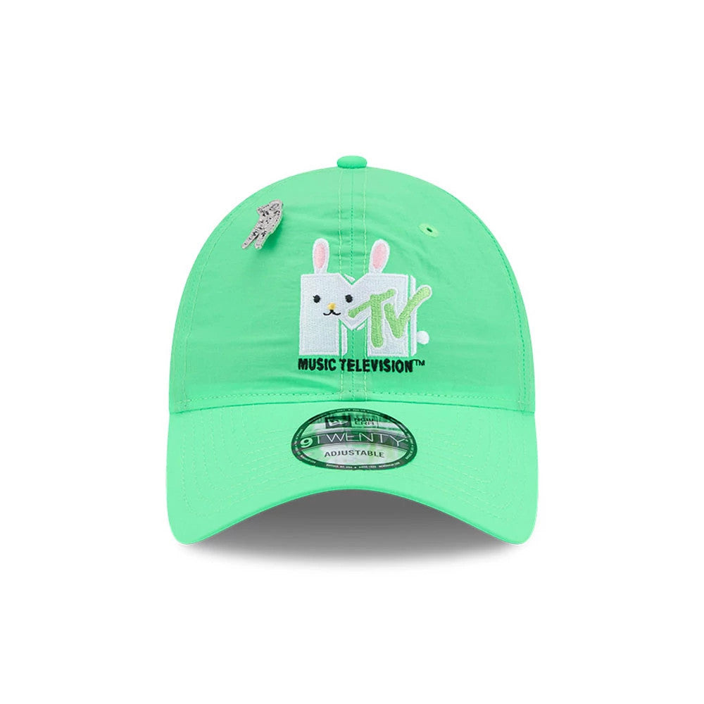MTV Logo Bright Green New Era 9TWENTY Adjustable Cap, front view showing the embroidered white and pink MTV logo with a playful character on the front panel, a silver astronaut pin above it and a 9TWENTY size sticker on the curved visor.