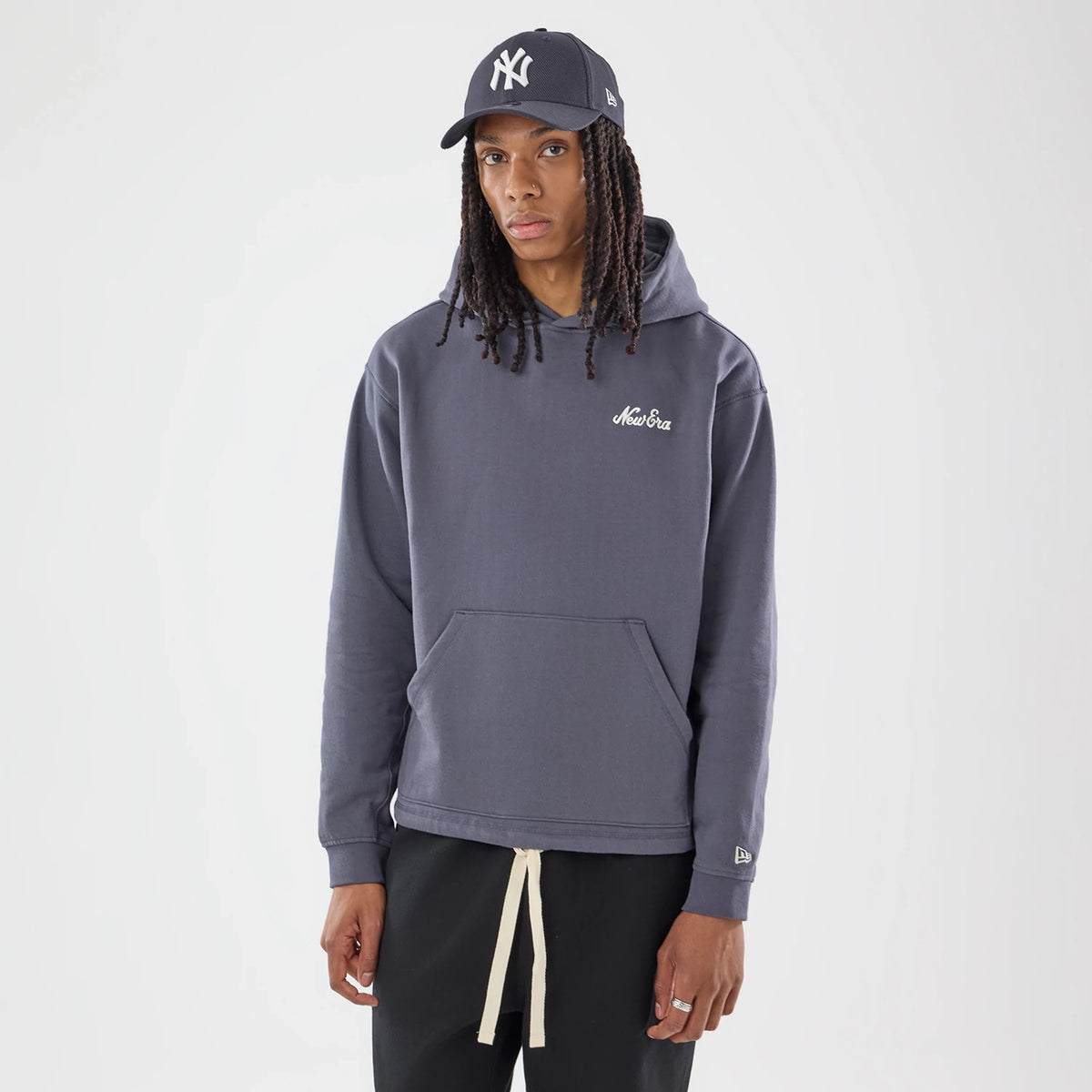 The model is wearing this New Era Open Hem Pullover Hoodie in grey. 1