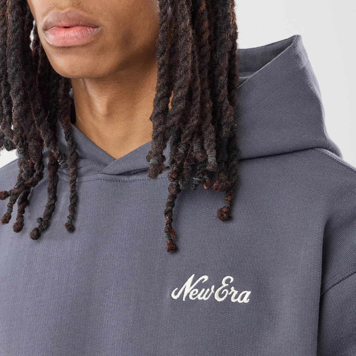 The model is wearing this New Era Open Hem Pullover Hoodie in grey. 4