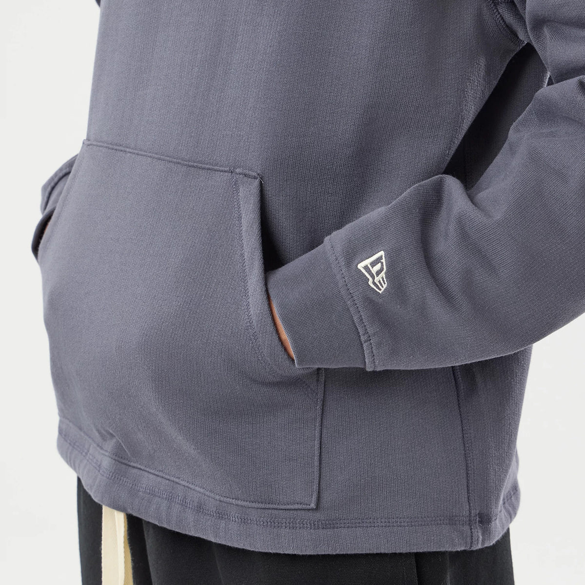 The model is wearing this New Era Open Hem Pullover Hoodie in grey. 5
