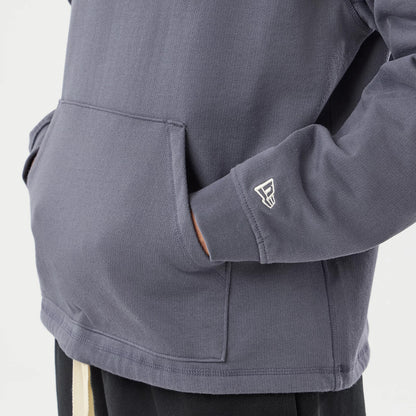 The model is wearing this New Era Open Hem Pullover Hoodie in grey. 5