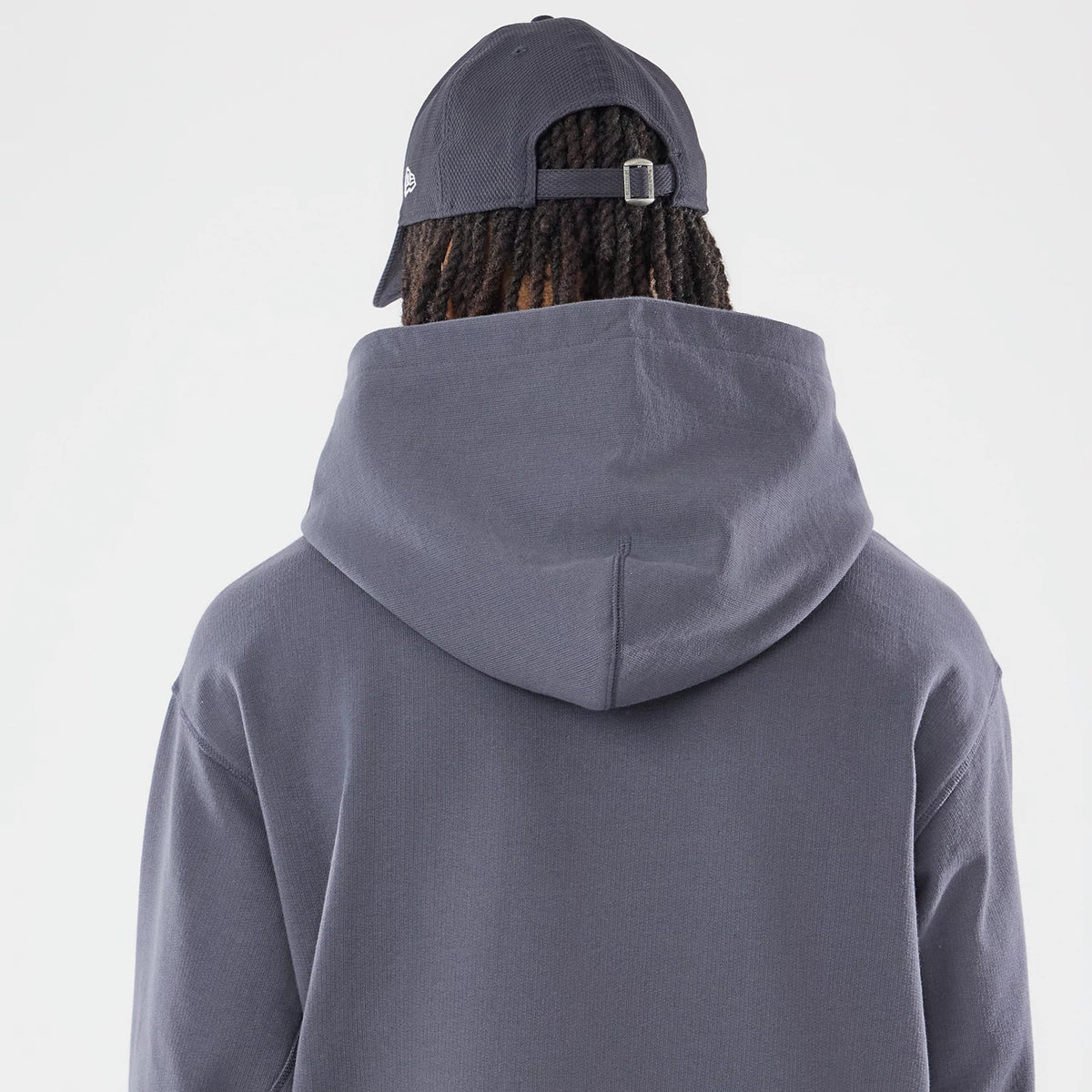 The model is wearing this New Era Open Hem Pullover Hoodie in grey. 7