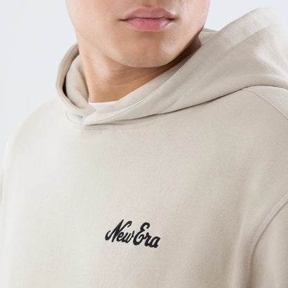 The model is wearing this New Era Open Hem Pullover Hoodie in light beige. 3