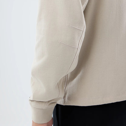 The model is wearing this New Era Open Hem Pullover Hoodie in light beige. 6