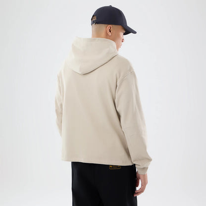 The model is wearing this New Era Open Hem Pullover Hoodie in light beige. 2