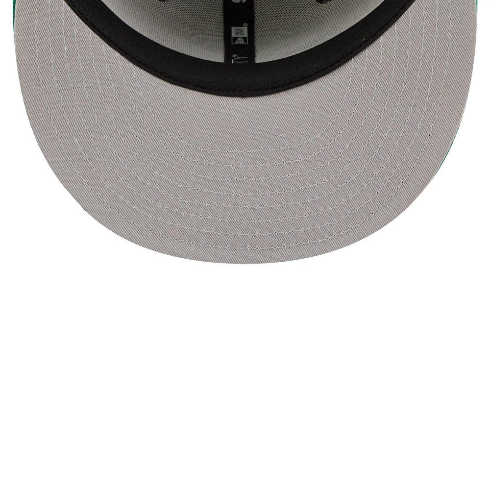 Philadelphia Eagles NFL Camo & Green New Era 9FIFTY Snapback Adjustable Cap, inside view showing the grey undervisor, black sweatband, and branded taping along the seams with a small size sticker near the centre.