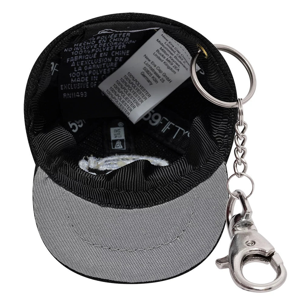 The model is wearing this Gettomasa X New Era Key Chain in black. 2
