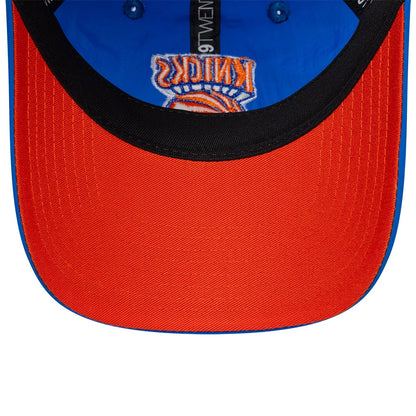 New York Knicks NBA Hardwood Classic Nylon Blue New Era 9TWENTY Adjustable Cap, inside view showing orange undervisor, black sweatband with 9TWENTY branding, and blue fabric with New York Knicks logo stitching on the crown.