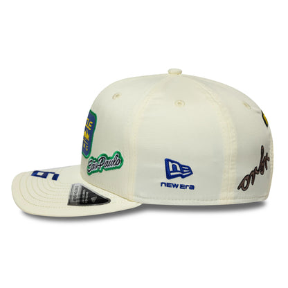 Red Bull Racing Brazil Race Special Isack Hadjar Cream New Era 9SEVENTY Stretch Snap Adjustable Cap, side view showing the São Paulo embroidered patch in green and white, New Era logo in blue on the side panel.