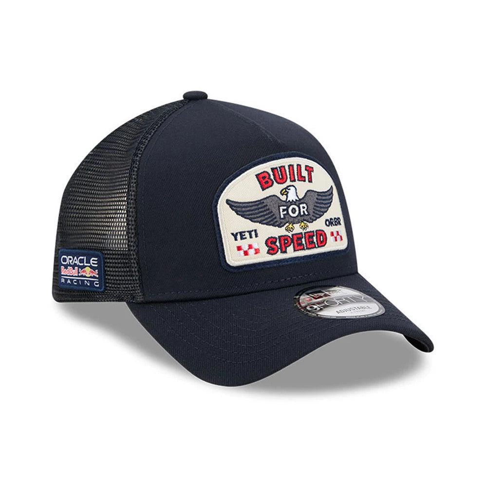 Red Bull Racing Yeti X Red Bull Racing Black New Era 9FORTY A-Frame Trucker Adjustable Cap, three-quarter view showing the large embroidered patch with a winged eagle and 'Built for Speed' text on the front panel, with a curved black visor.