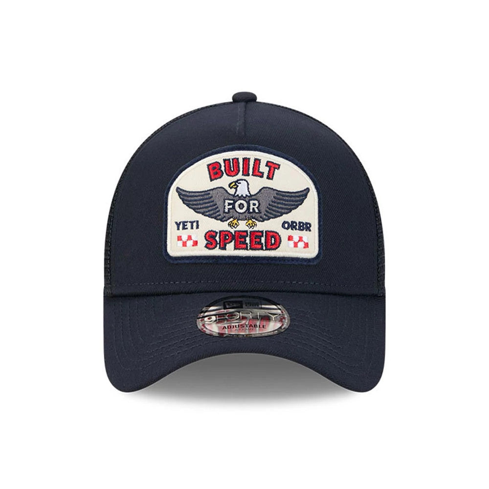 Red Bull Racing Yeti X Red Bull Racing Black New Era 9FORTY A-Frame Trucker Adjustable Cap, front view showing a Built for Speed embroidered patch with an eagle on the front panel, black curved visor, and 9FORTY size sticker placed centrally.