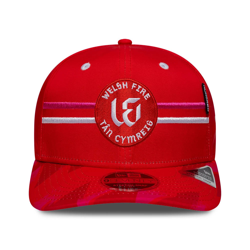 Welsh Fire Tan Cymreig The Hundred 2026 Red New Era 9SEVENTY Stretch Snap Adjustable Cap, front view showing the central red and white embroidered logo on the structured red crown, with red visor and 9SEVENTY size sticker.