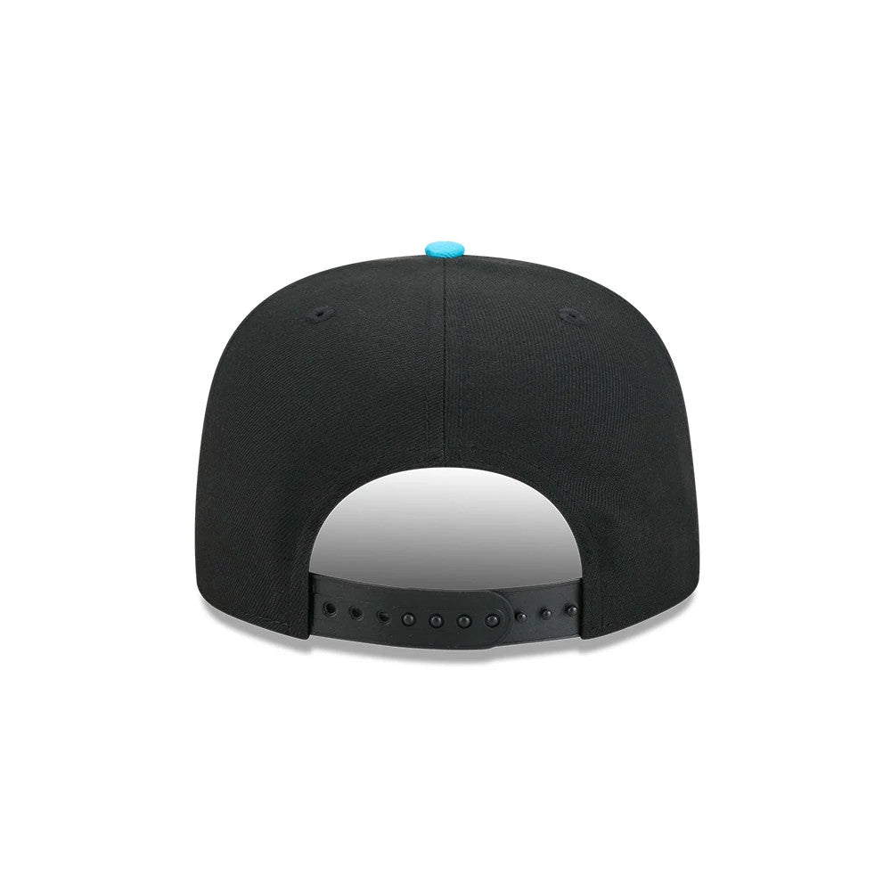 LA Dodgers MLB Electrocute Black New Era 9FIFTY A-Frame Snapback Adjustable Cap, rear view showing the black snapback closure for adjustable sizing, highlighted by a blue top button and black embroidered eyelets on the structured black crown.