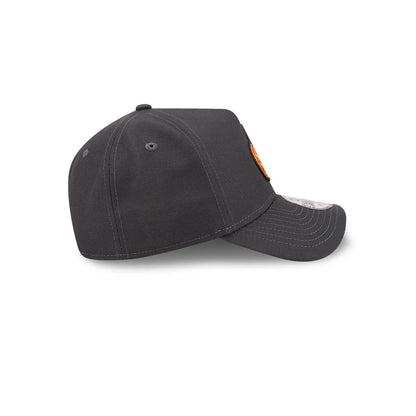 New Era Jack O Lantern Black 9FORTY A-Frame Adjustable Cap, side view showing grey structured crown with embroidered eyelets, the New Era flag logo on the left side, and pre-curved matching black visor with a 9FORTY size sticker.